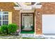 Close-up of the front door and entrance, featuring plants and yellow shutters at 8531 Spivey Village Trl, Jonesboro, GA 30236