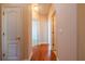 Hallway with hardwood floors and doors leading to various rooms at 8531 Spivey Village Trl, Jonesboro, GA 30236