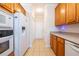 Kitchen view with refrigerator, range, tiled flooring and oak cabinets at 8531 Spivey Village Trl, Jonesboro, GA 30236