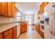 Bright kitchen with oak cabinets, stainless steel appliances, and tiled floors at 8531 Spivey Village Trl, Jonesboro, GA 30236