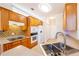 Open kitchen with tile floors, stainless steel sink, and oak cabinets at 8531 Spivey Village Trl, Jonesboro, GA 30236