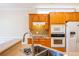 Kitchen view with oak cabinets, tiled backsplash and stainless steel appliances at 8531 Spivey Village Trl, Jonesboro, GA 30236