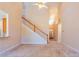Bright living room showing staircase and view into the foyer at 8531 Spivey Village Trl, Jonesboro, GA 30236
