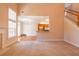 Spacious living room showing staircase and a view into the dining room and kitchen at 8531 Spivey Village Trl, Jonesboro, GA 30236