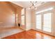 Bright living room features wood floors, fireplace, and natural light from the windows at 8531 Spivey Village Trl, Jonesboro, GA 30236