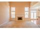 Bright living room with fireplace, large windows, and doorway to the deck at 8531 Spivey Village Trl, Jonesboro, GA 30236