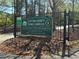 Clayton County Tennis Complex sign with gated entrance surrounded by lush greenery and mature trees at 8531 Spivey Village Trl, Jonesboro, GA 30236