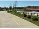 Paved walking trail with yellow lines, leading towards recreational areas and lush green spaces at 8531 Spivey Village Trl, Jonesboro, GA 30236