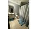 Cozy bathroom with white vanity, standard toilet, and patterned shower curtain at 2180 Ridge Rd, Canton, GA 30114