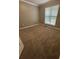Clean bedroom with neutral carpet and light filled from window making it inviting at 2180 Ridge Rd, Canton, GA 30114