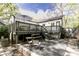 Private backyard with deck, stone patio, and lush landscaping, ideal for relaxing at 308 Greenwood Ave, Decatur, GA 30030