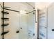 Tiled bathtub with glass enclosure and integrated shelving for storage at 308 Greenwood Ave, Decatur, GA 30030