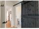 Bathroom with toilet featuring beadboard wainscoting and sliding barn door entrance at 308 Greenwood Ave, Decatur, GA 30030
