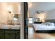 Bedroom with ensuite bathroom featuring sliding barn door, double sinks, and hardwood floors at 308 Greenwood Ave, Decatur, GA 30030