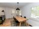 Dining room with wooden table, hardwood floors, white walls, and bright windows at 308 Greenwood Ave, Decatur, GA 30030