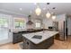 Modern kitchen featuring a large island, stainless steel appliances, and stylish pendant lighting at 308 Greenwood Ave, Decatur, GA 30030