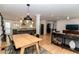 Open-concept living and dining area with hardwood floors and modern light fixtures at 308 Greenwood Ave, Decatur, GA 30030