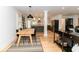 Open-concept living and dining area with hardwood floors and modern light fixtures at 308 Greenwood Ave, Decatur, GA 30030