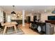Open-concept living and dining area with hardwood floors and modern light fixtures at 308 Greenwood Ave, Decatur, GA 30030