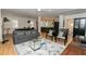 Bright living room with hardwood floors, modern decor, and open floor plan to the kitchen at 308 Greenwood Ave, Decatur, GA 30030