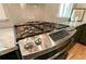 Close-up of stainless steel gas cooktop with granite countertops and natural light at 308 Greenwood Ave, Decatur, GA 30030
