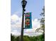 Decorative street lamp banner showcasing neighborhood architecture and branding for the Oakhurst District at 308 Greenwood Ave, Decatur, GA 30030
