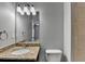 Bathroom featuring a single sink with granite counters and a wall mirror at 3330 Camellia Ln, Suwanee, GA 30024