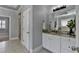 This bright bathroom has tile floors, double sinks with granite countertops, and a shower room at 3330 Camellia Ln, Suwanee, GA 30024