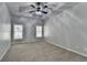Bedroom featuring a ceiling fan, trey ceiling, plush carpet and bright windows at 3330 Camellia Ln, Suwanee, GA 30024