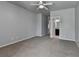 Neutral bedroom featuring a ceiling fan, plush carpet and an attached bathroom area at 3330 Camellia Ln, Suwanee, GA 30024