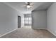 Neutral bedroom featuring a ceiling fan, plush carpet and plantation shutters at 3330 Camellia Ln, Suwanee, GA 30024