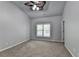 Empty bedroom with a ceiling fan and large window providing lots of natural light at 3330 Camellia Ln, Suwanee, GA 30024