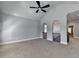 Spacious bonus room with vaulted ceiling, ceiling fan, and carpeted floor; perfect for entertaining at 3330 Camellia Ln, Suwanee, GA 30024