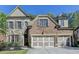 Charming brick and stone home with a three-car garage and manicured front yard at 3330 Camellia Ln, Suwanee, GA 30024
