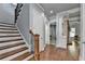 Entryway with hardwood stairs, an open floor plan, and detailed trim work at 3330 Camellia Ln, Suwanee, GA 30024