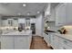 Spacious kitchen with white cabinets, stainless steel appliances, stone countertops and island seating at 3330 Camellia Ln, Suwanee, GA 30024