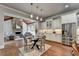 Spacious kitchen featuring white cabinets, dining area and stainless steel appliances at 3330 Camellia Ln, Suwanee, GA 30024