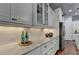Kitchen view of white cabinets with stone countertop and stainless steel appliances at 3330 Camellia Ln, Suwanee, GA 30024