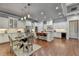 Bright open kitchen featuring white cabinets, stone countertops and a dining area at 3330 Camellia Ln, Suwanee, GA 30024