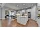 Kitchen featuring stone countertops, white cabinets and stainless steel appliances overlooking the living room at 3330 Camellia Ln, Suwanee, GA 30024