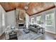 Inviting living room with stone fireplace, wood ceiling and natural light at 3330 Camellia Ln, Suwanee, GA 30024