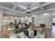 Open-concept living area with coffered ceilings, hardwood floors, and access to the kitchen at 3330 Camellia Ln, Suwanee, GA 30024
