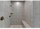 Shower featuring neutral tiling, a built-in bench and bronze hardware at 3330 Camellia Ln, Suwanee, GA 30024