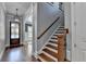 Elegant staircase with wooden banister and decorative lighting, blending charm and functionality at 3330 Camellia Ln, Suwanee, GA 30024
