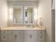 Elegant bathroom featuring double sinks, a marble countertop, and modern lighting fixtures above the mirrors at 3630 Peachtree Ne Rd # 3207, Atlanta, GA 30326