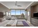 Modern bedroom with floor-to-ceiling windows offering skyline views, neutral tones, and a ceiling fan at 3630 Peachtree Ne Rd # 3207, Atlanta, GA 30326