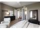 Bright, modern bedroom with hardwood floors, artwork, and a sitting area with floor-to-ceiling windows at 3630 Peachtree Ne Rd # 3207, Atlanta, GA 30326