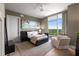 Serene bedroom with a large window, hardwood floors, and a comfortable seating area at 3630 Peachtree Ne Rd # 3207, Atlanta, GA 30326