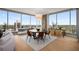 Dining room with modern furnishings, sleek wood floors, and city views at 3630 Peachtree Ne Rd # 3207, Atlanta, GA 30326