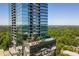 High-rise building with balconies, a rooftop pool, and lush greenery on a sunny day at 3630 Peachtree Ne Rd # 3207, Atlanta, GA 30326
